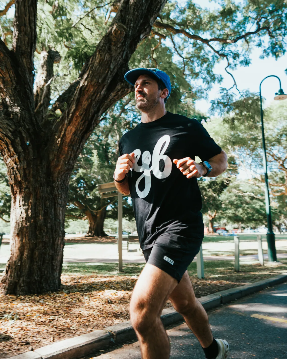 Lachlan Stuart running on a tree lined path in Brisbane.